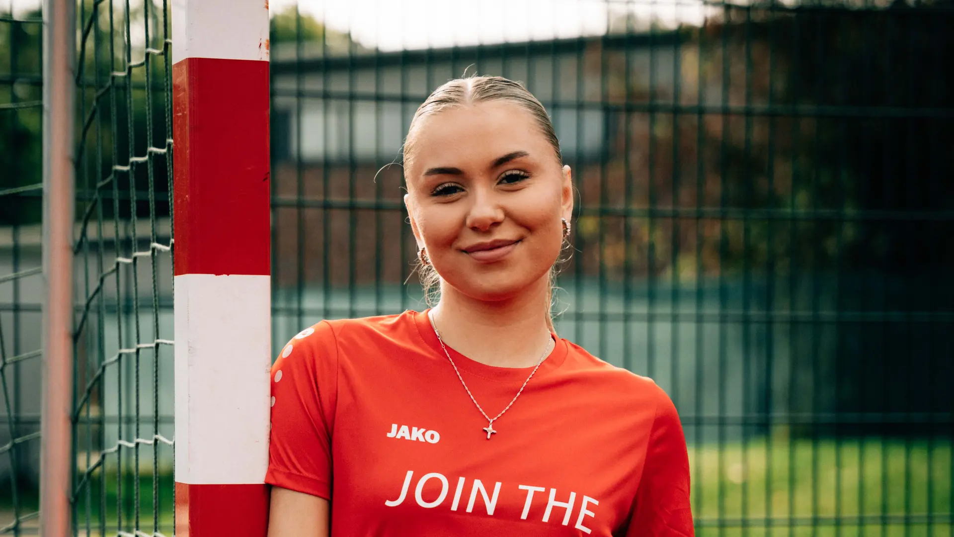 Fussballspielerin Zaun Querformat